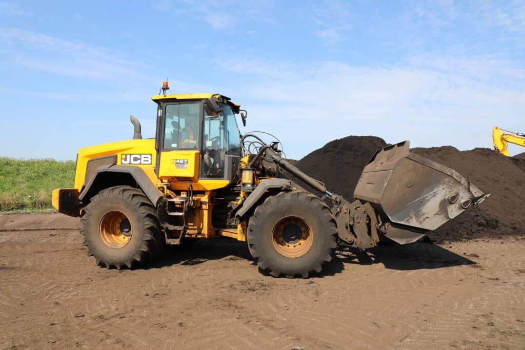 JCB 427 with BAC high tip bucket waste moving