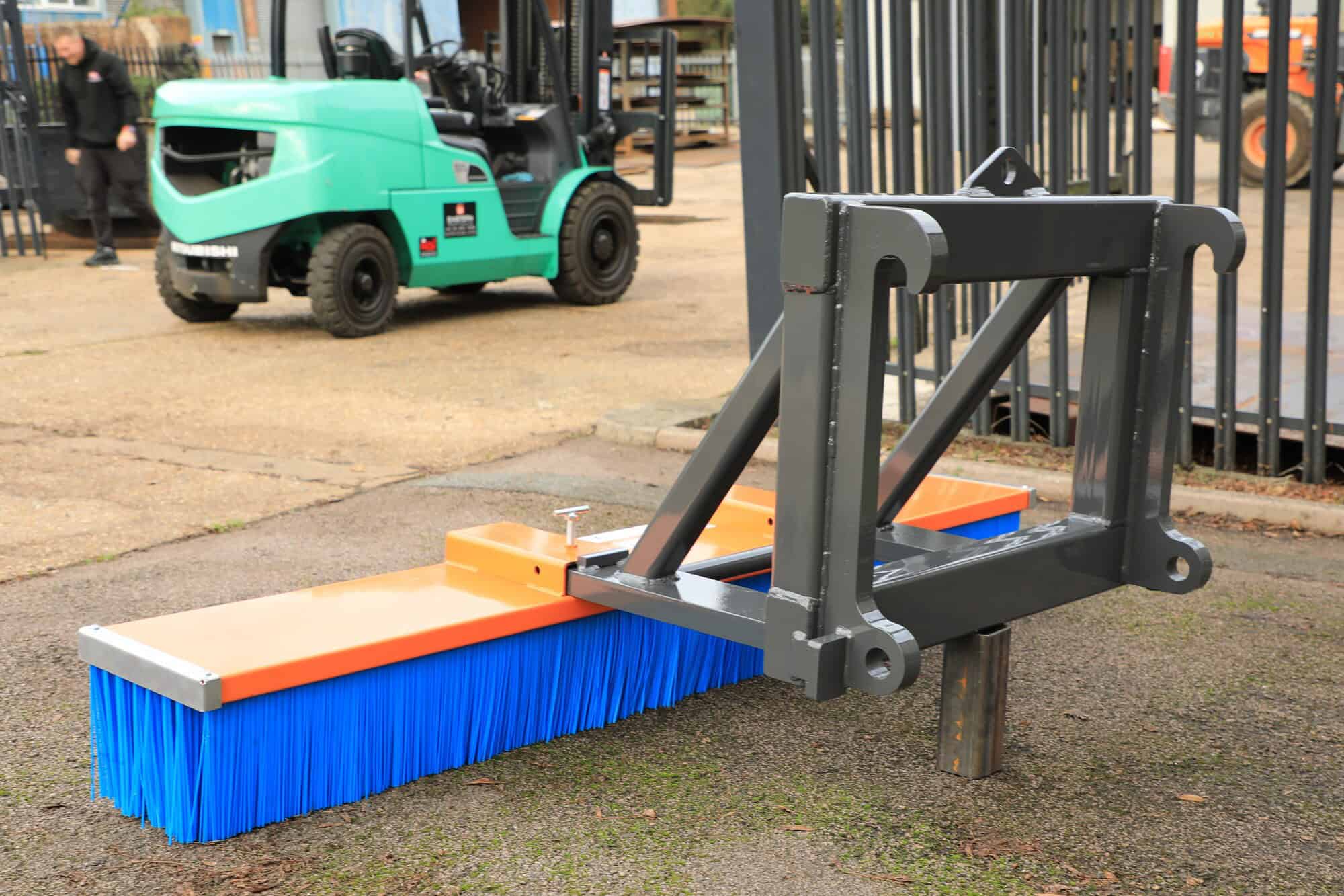 Fork mounted brush bracket and Brush BA Caulkett loading shovel attachments